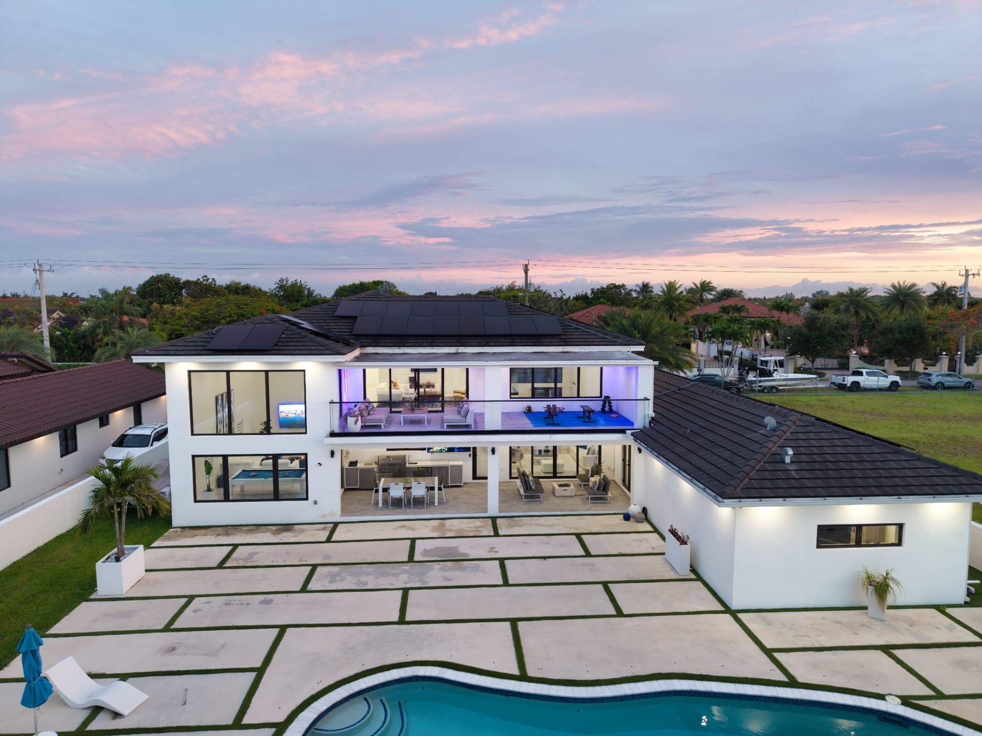 Rear aerial of the estate at sunset showing terrace and pool