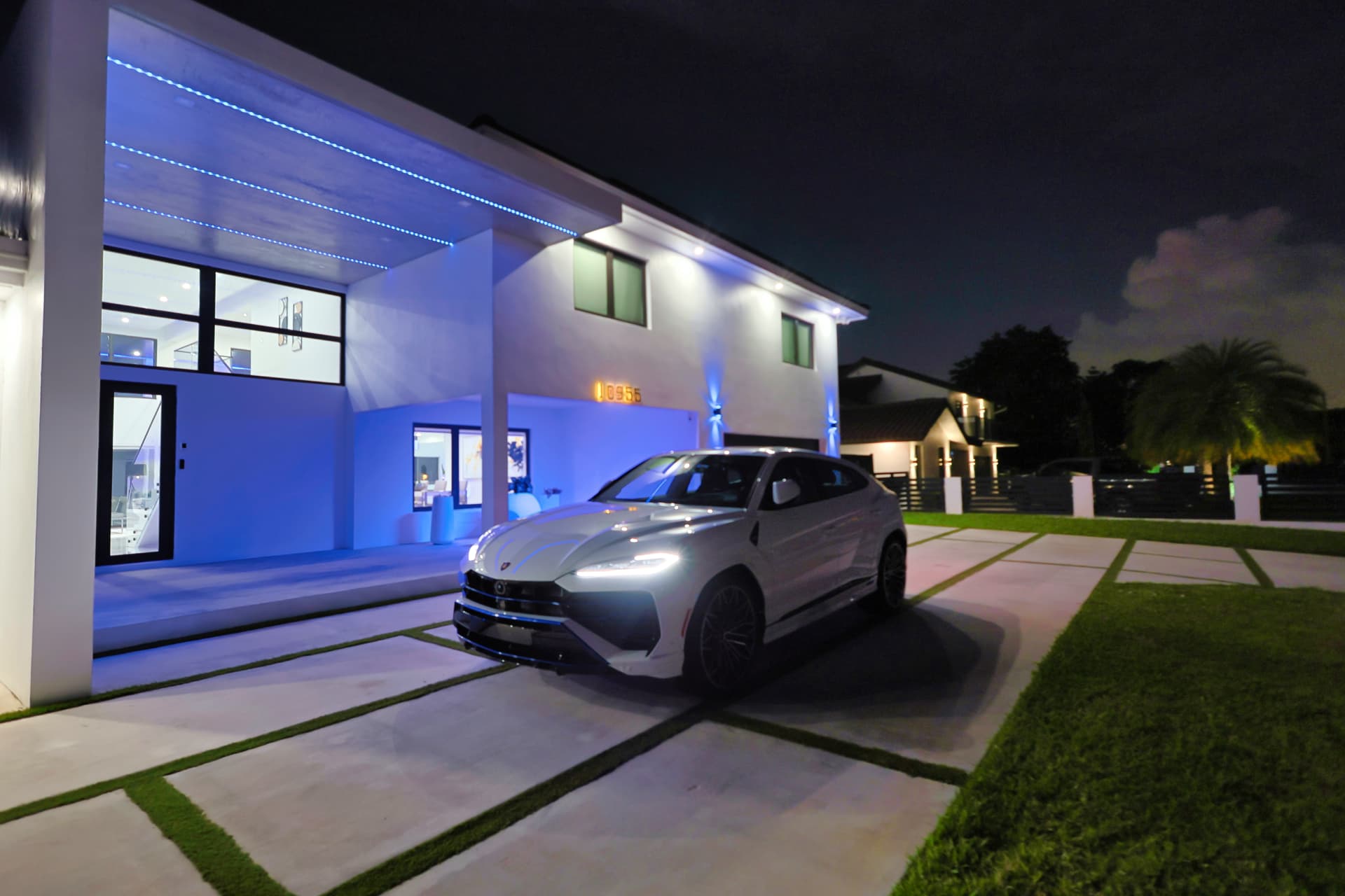 Night driveway shot with luxury SUV and LED lighting